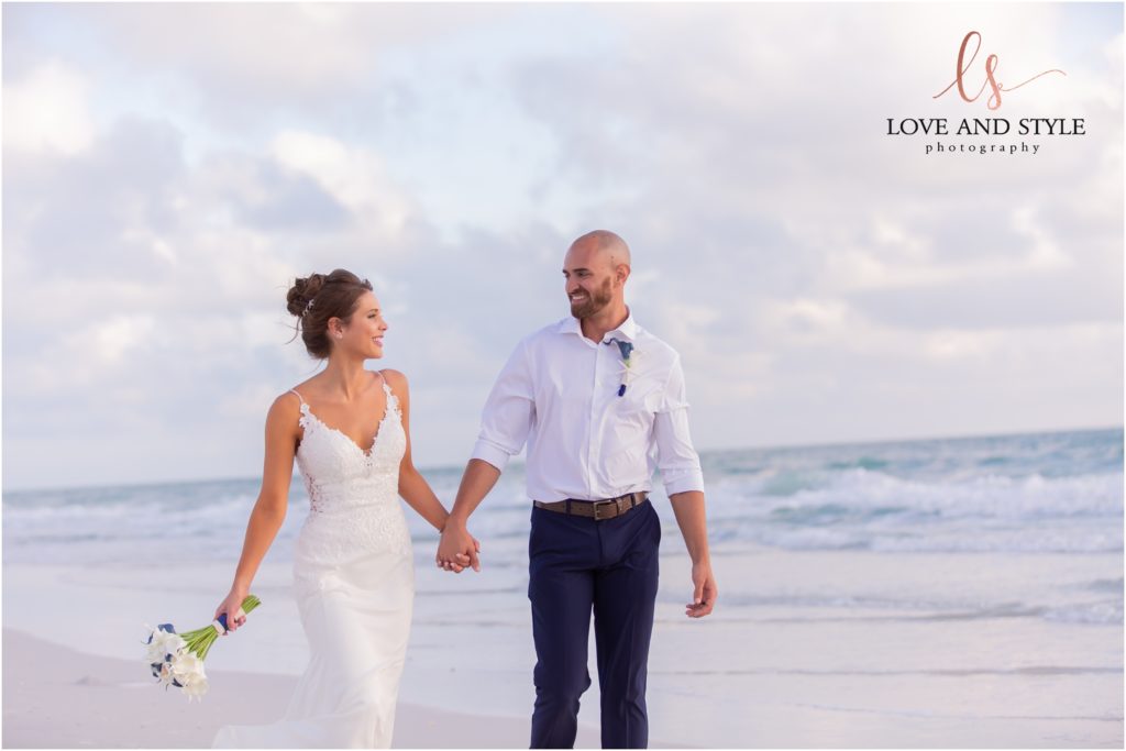 Wedding Photography at The Beach House, Anna Maria Island, bride and groom holding hands walking on the beach