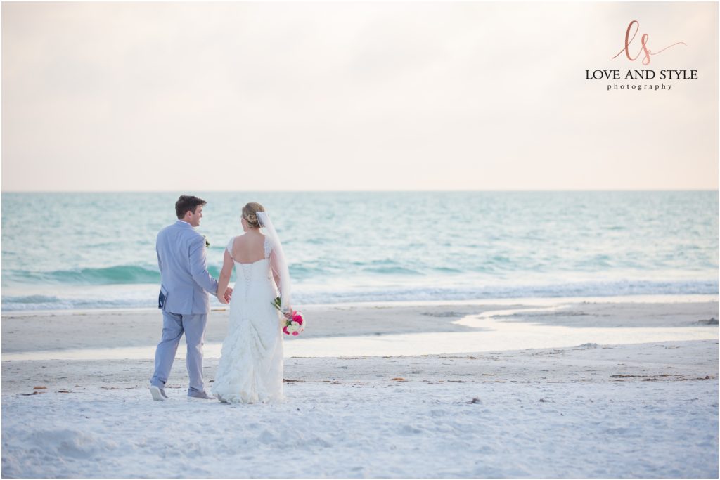 Anna Maria Island Wedding Photography at The Sandbar Restaurant, bride and groom walking on the beach