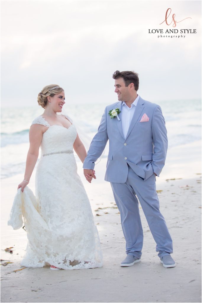 Anna Maria Island Wedding Photography at The Sandbar Restaurant, bride and groom holding hands on the beach