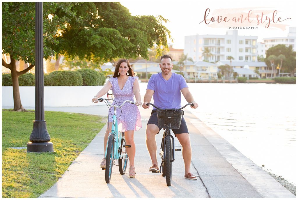 Engagement Photography in Sarasota, Fl at Bayfront Park, couple are riding parks along the sidewalk
