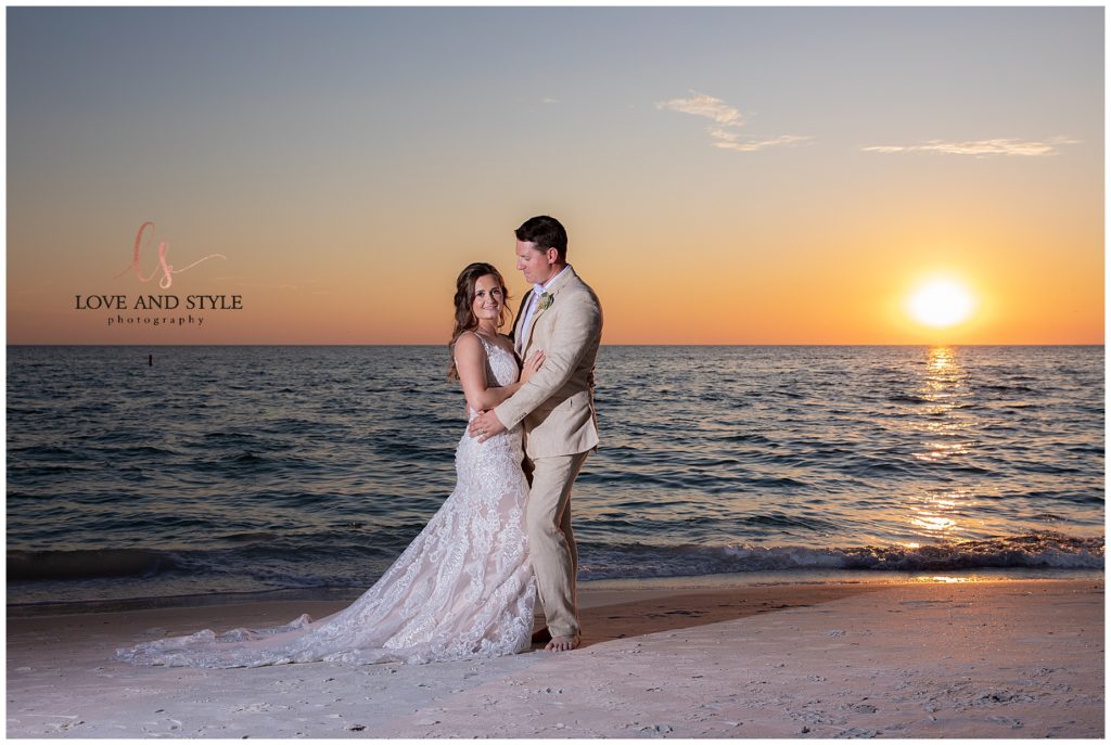 Bride and groom with the sunset on the beach for their Intimate Anna Maria Island Wedding