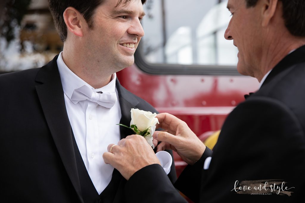 Groom getting his boutonniere on before his Gorgeous Sarasota Wedding