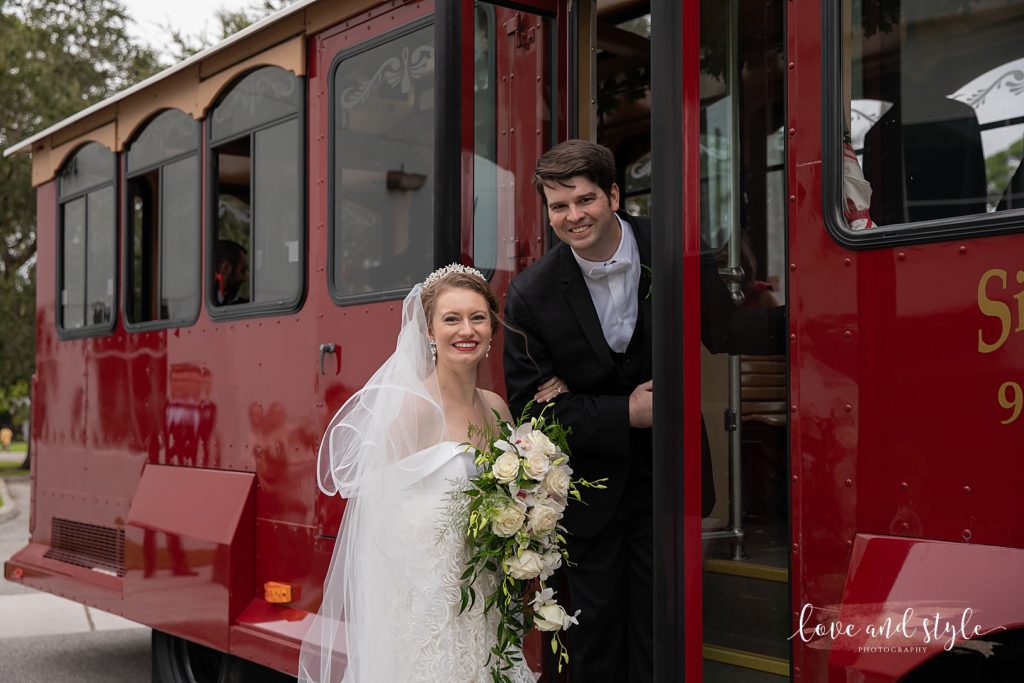 Bride and Groom getting on the red Siesta Key Trolley