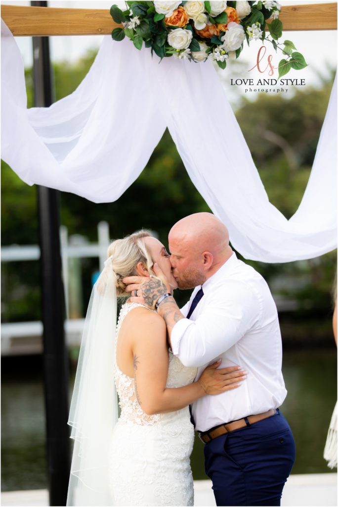 Bride and Groom's first kiss at The Waterline Marina on Anna Maria Island
