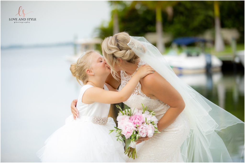 Bride kissing her daughter and flower girl after their wedding at The Waterline Resort on Anna Maria Island