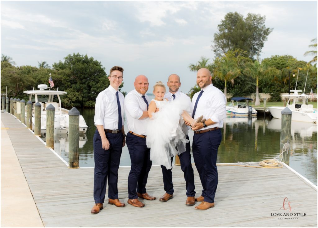 Groom with groomsmen on the dock behind The Waterline Marina after this Anna Maria Island Wedding.