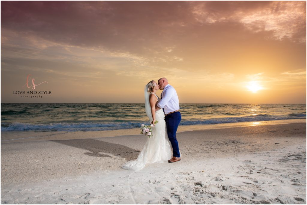 Bride and Groom kissing on and Anna Maria Island Beach at sunset