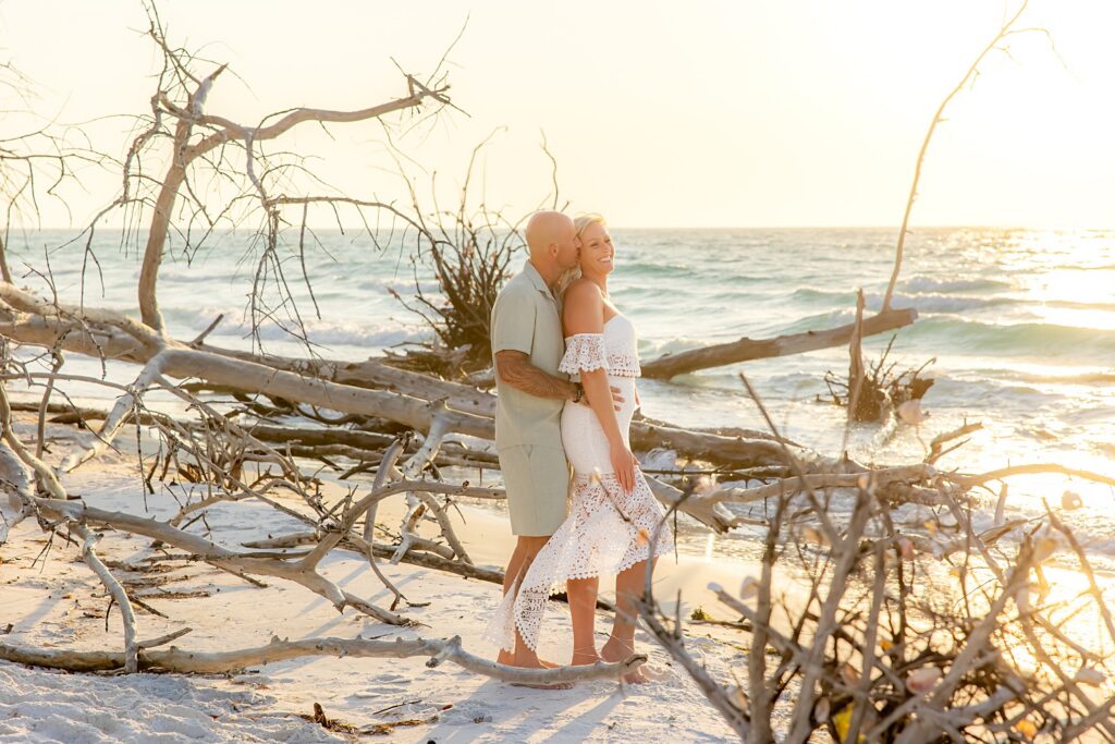 Engaged Couple in front of the driftwood on Longboat Key