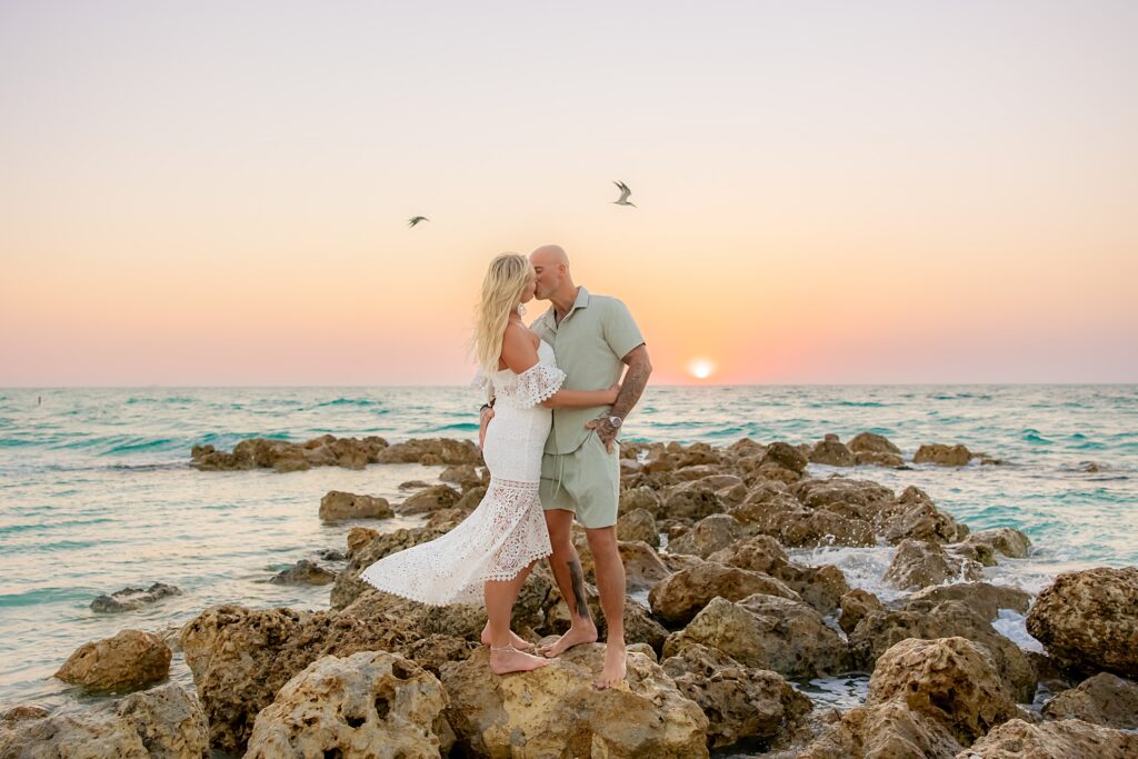 Engaged couple on the rocks on Longboat Key