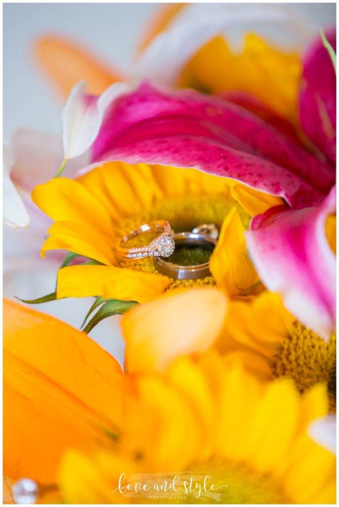 rose-gold-wedding-rings-in-sunflower-bouquet