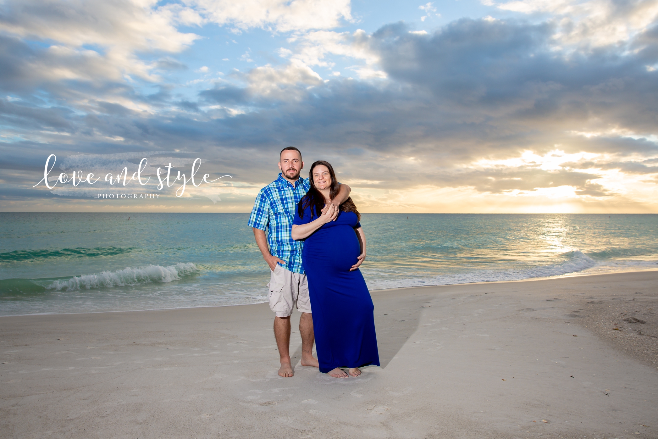 Holmes Beach Photographer with pregnant couple wearing blue on the beach at sunset