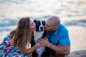 Venice Dog Beach Engagement photo with couple and their black and white dog at sunset