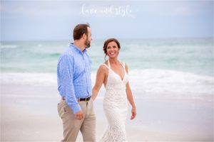 Beach House Wedding Bride and Groom holding hands walking down the beach