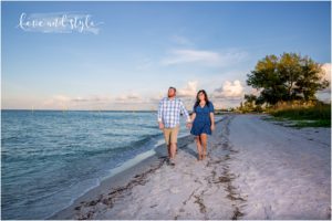 Engagement Photography Anna Maria Island with couple holding hands walking along the beach