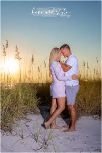 AMI Engagement Photography with couple in the seagrass at the beach during the sunset hour
