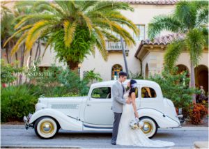 A Wedding at the Powel Crosley Estate with bride and groom in front of vintage car