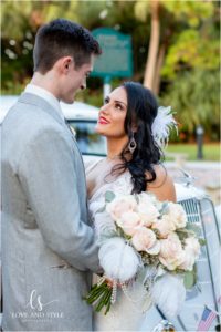 A Wedding at the Powel Crosley Estate with bride and groom in front of vintage car
