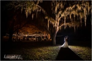 Barn at Chapel Creek Wedding, bride and groom with backlight under the large oak tree at night time