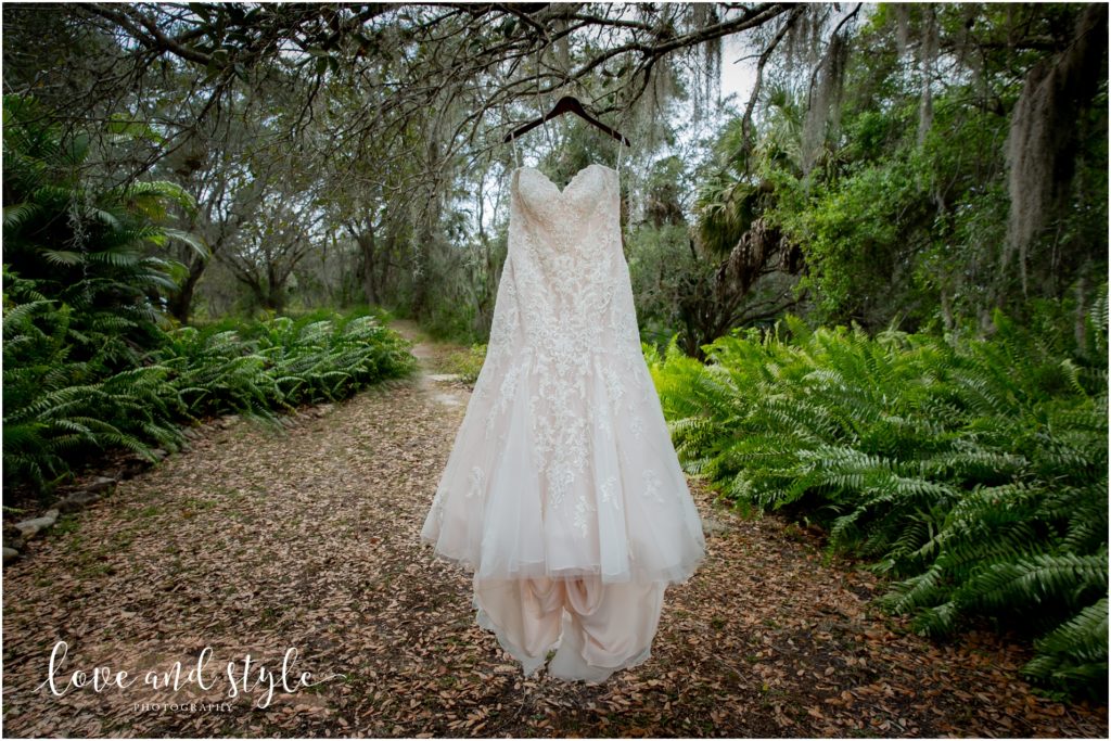 Sarasota Wedding Photographer at The Barn at Chapel Creek, photo of the dress hanging from a tree