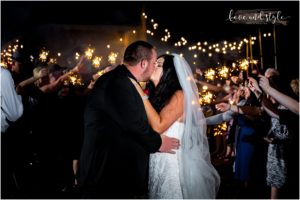 Sarasota Wedding Photographer at The Barn at Chapel Creek bride and groom kissing during sparkler exit