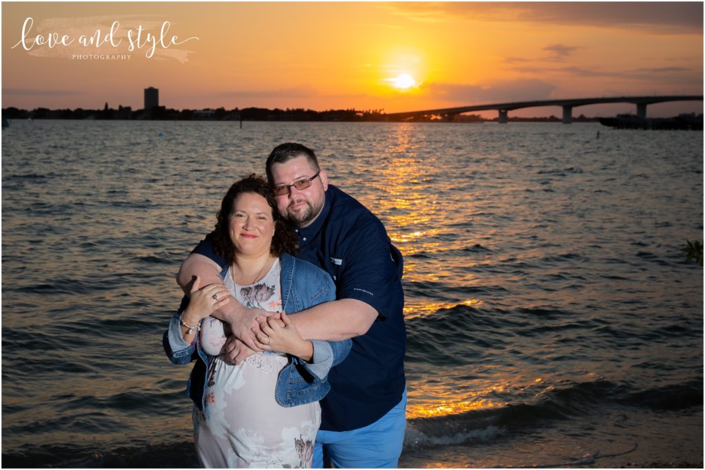 Engagement Photographer Sarasota with couple smiling at sunset