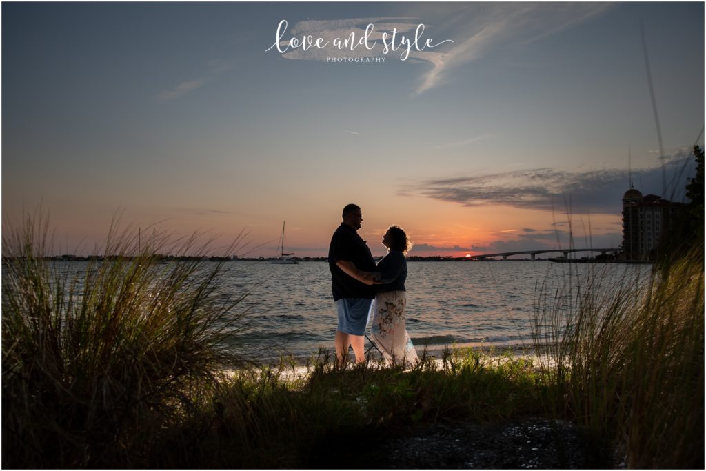 Engagement Photographer Sarasota with couple backlit on the beach