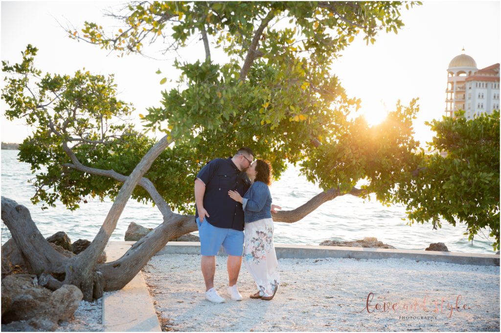 Engagement Photographer Sarasota with couple kissing under a tree