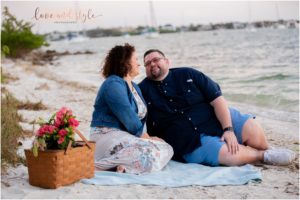 Engagement Photographer Sarasota with couple having a picnic on the beach