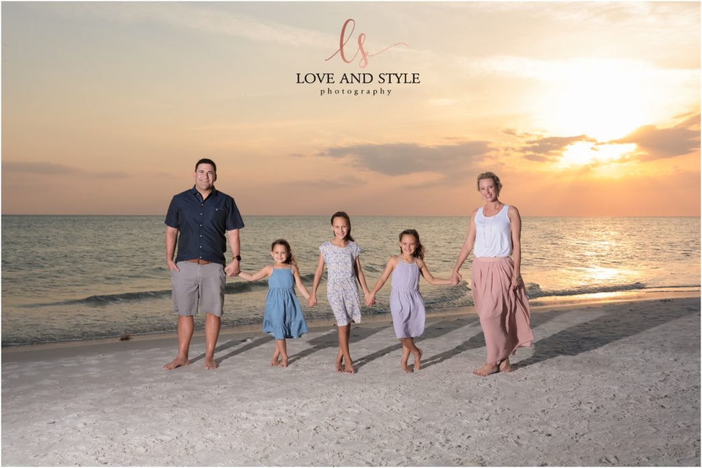 Siesta Key Family Photographer, the whole family holding hands on the beach at sunset
