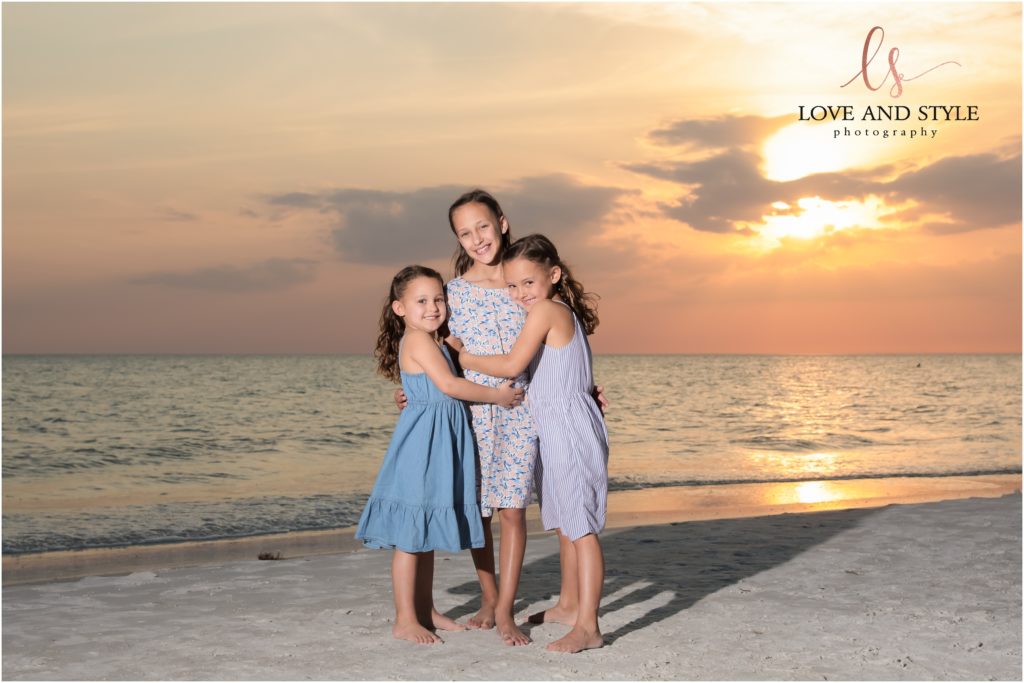 Siesta Key Family Photographer , picture of 3 sisters at sunset using off camera flash