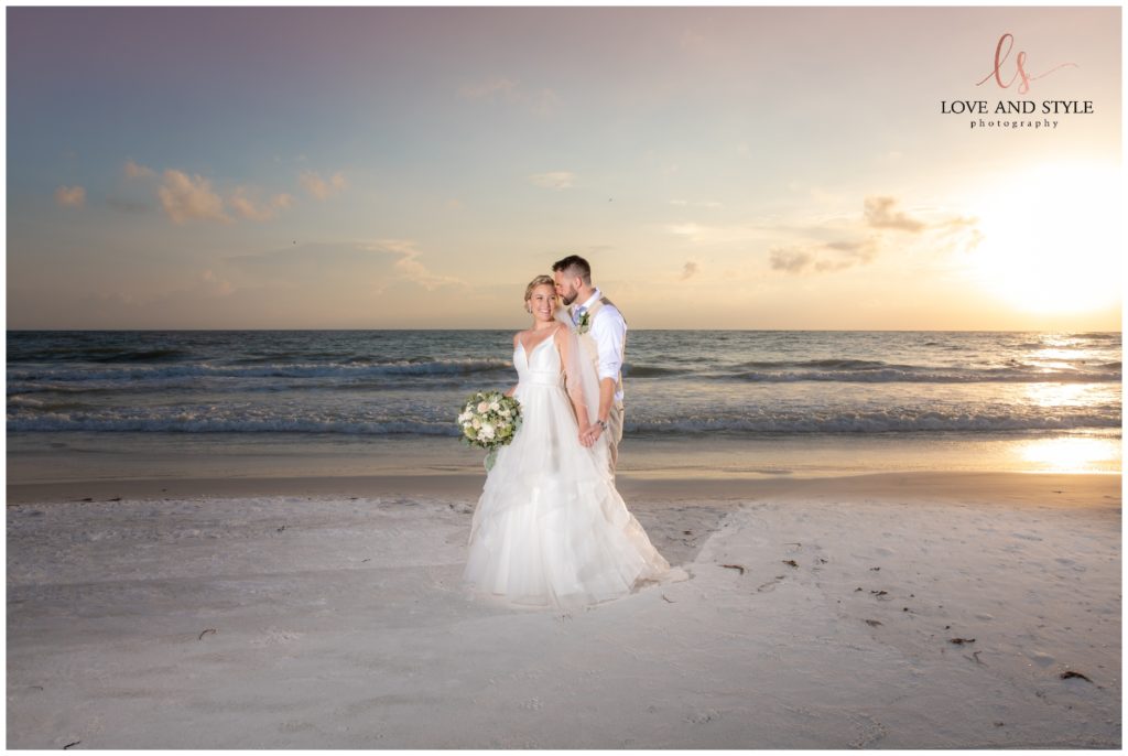 A bride and groom at sunset on the beach after their Wedding at The Sandbar, Anna Maria Island