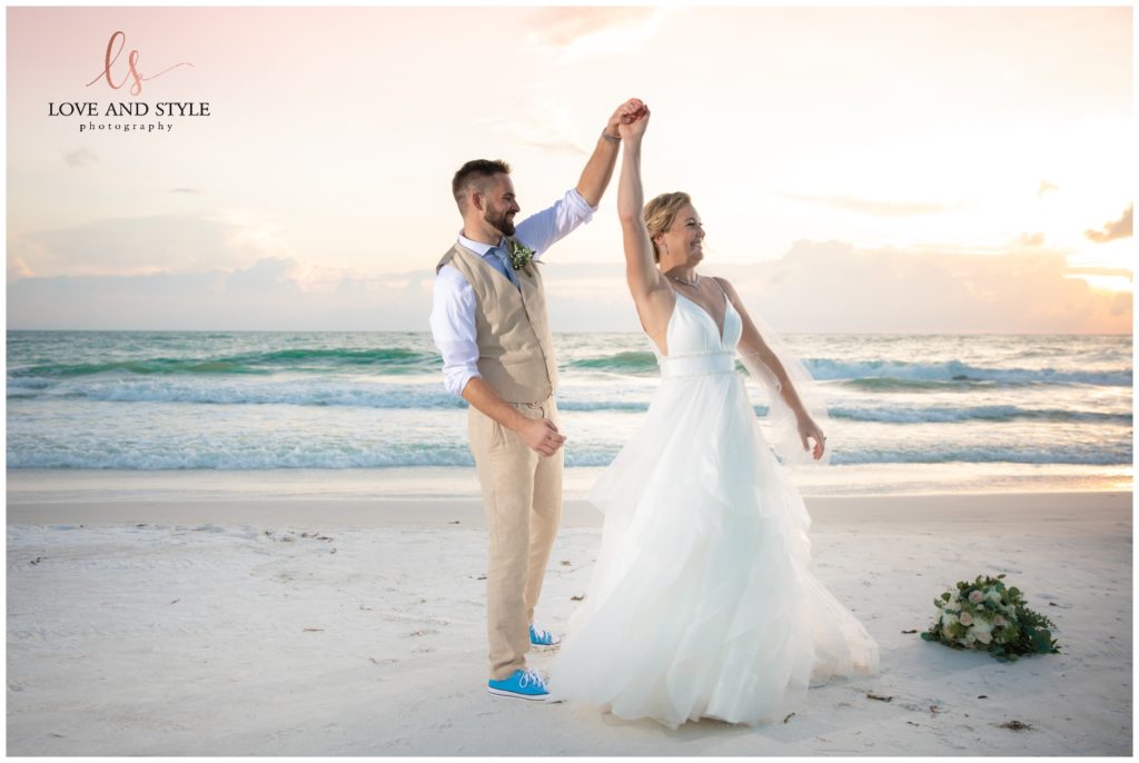 A bride and groom dancing on the beach after their Wedding at The Sandbar, Anna Maria Island