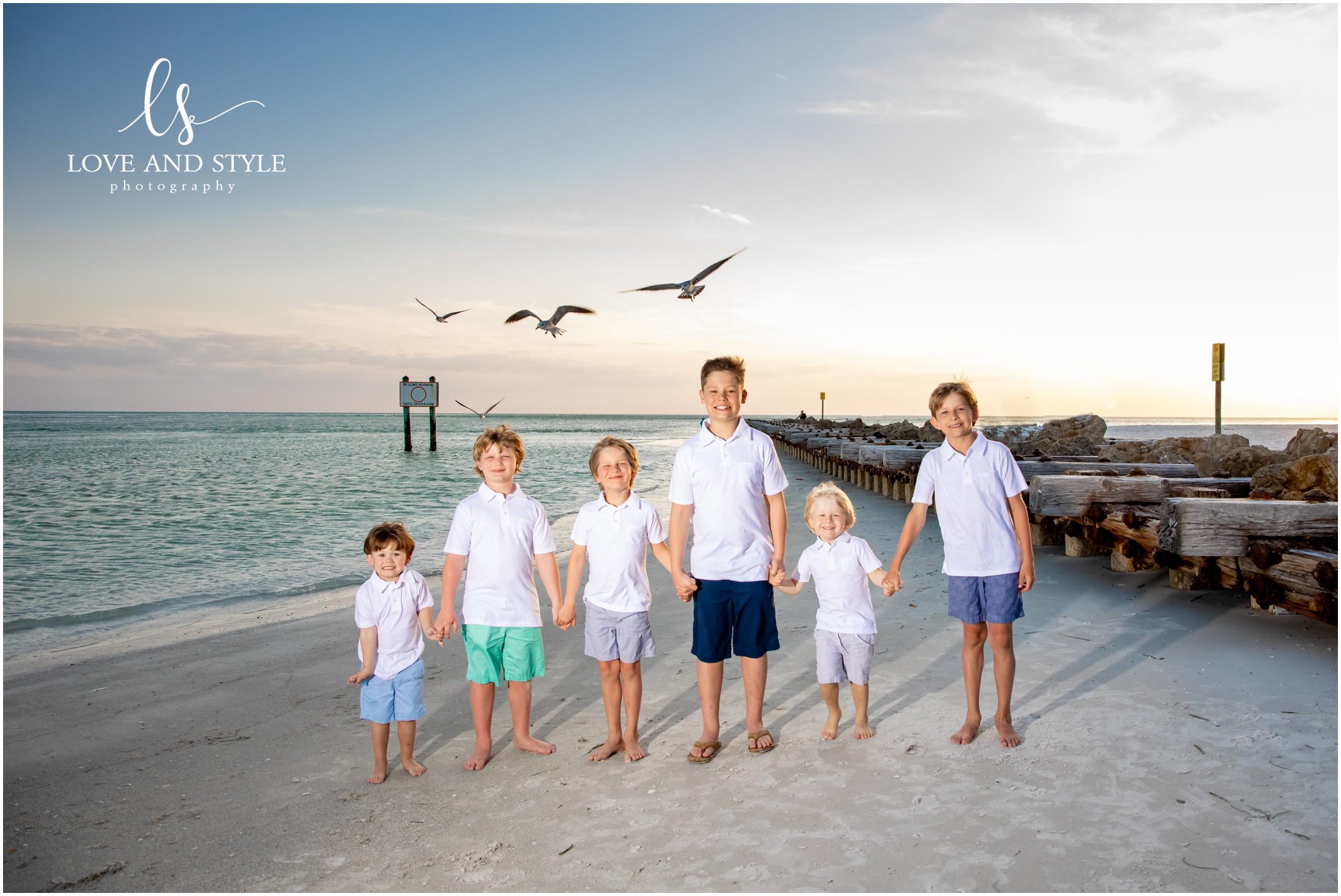 Family Photographer Anna Maria Island with the six kids together holding hands