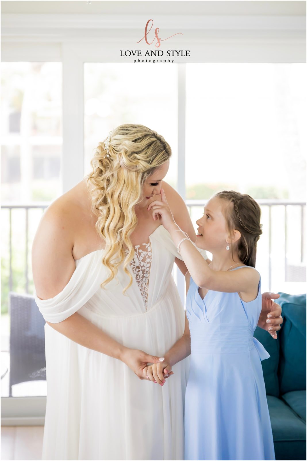 bride and daughter of the groom having a sweet moment before the ceremony