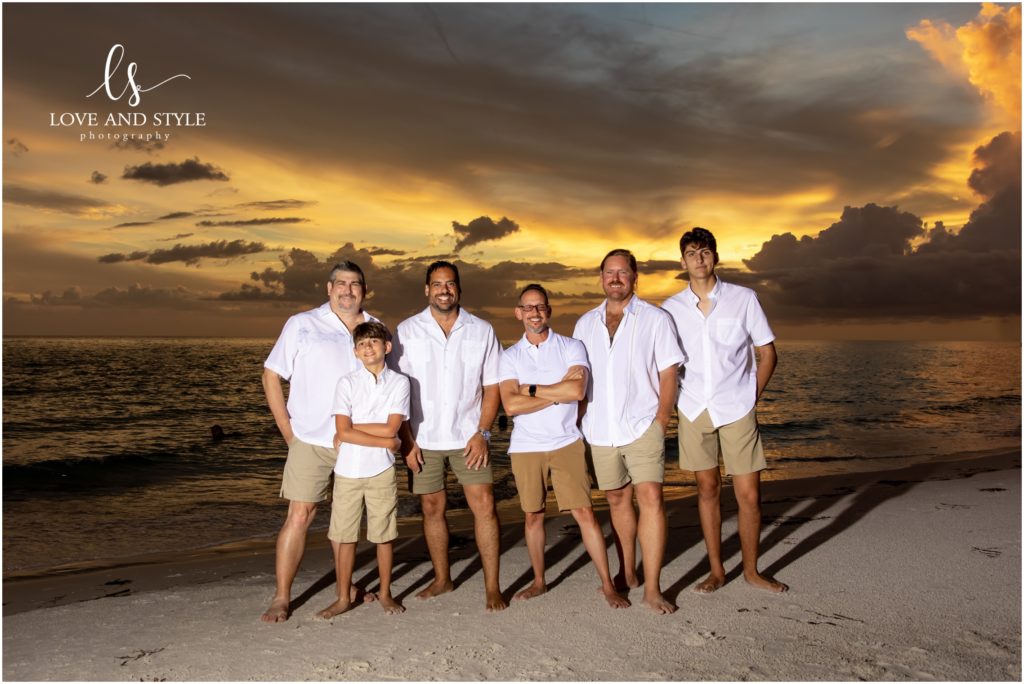 A photo of all the guys at sunset on the beach during their Anna Maria Island family session.