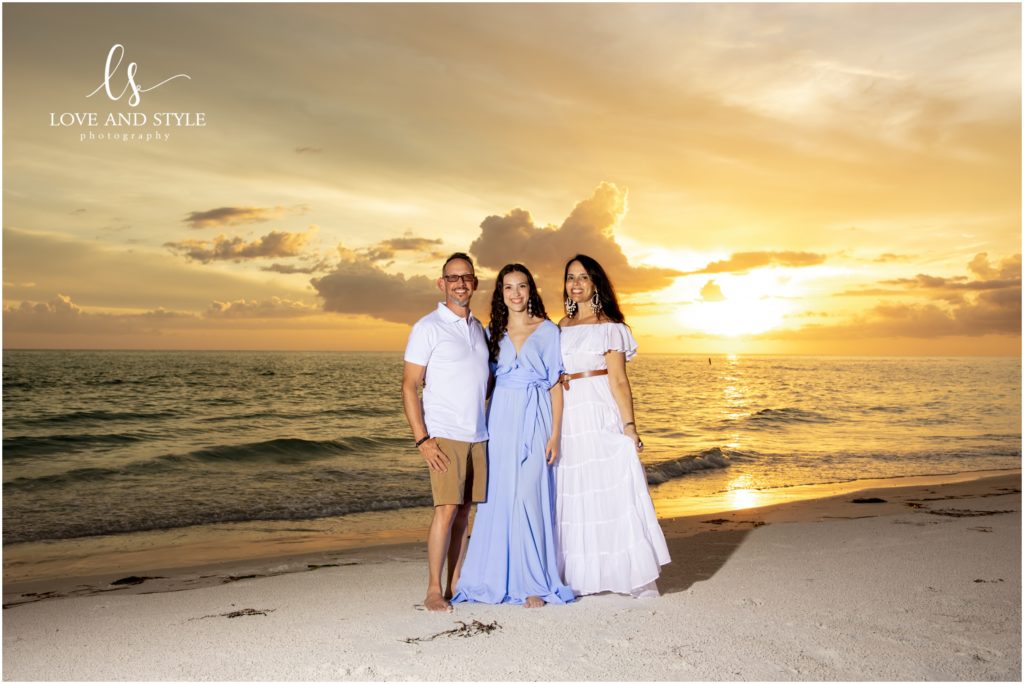 A family of three during their Anna Maria Island Family Photos session on the beach at sunset