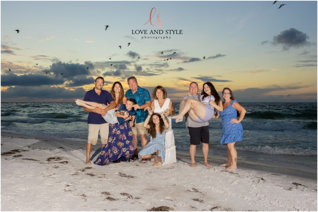 A silly family photo by Family Photographer on Anna Maria Island on the beach at sunset