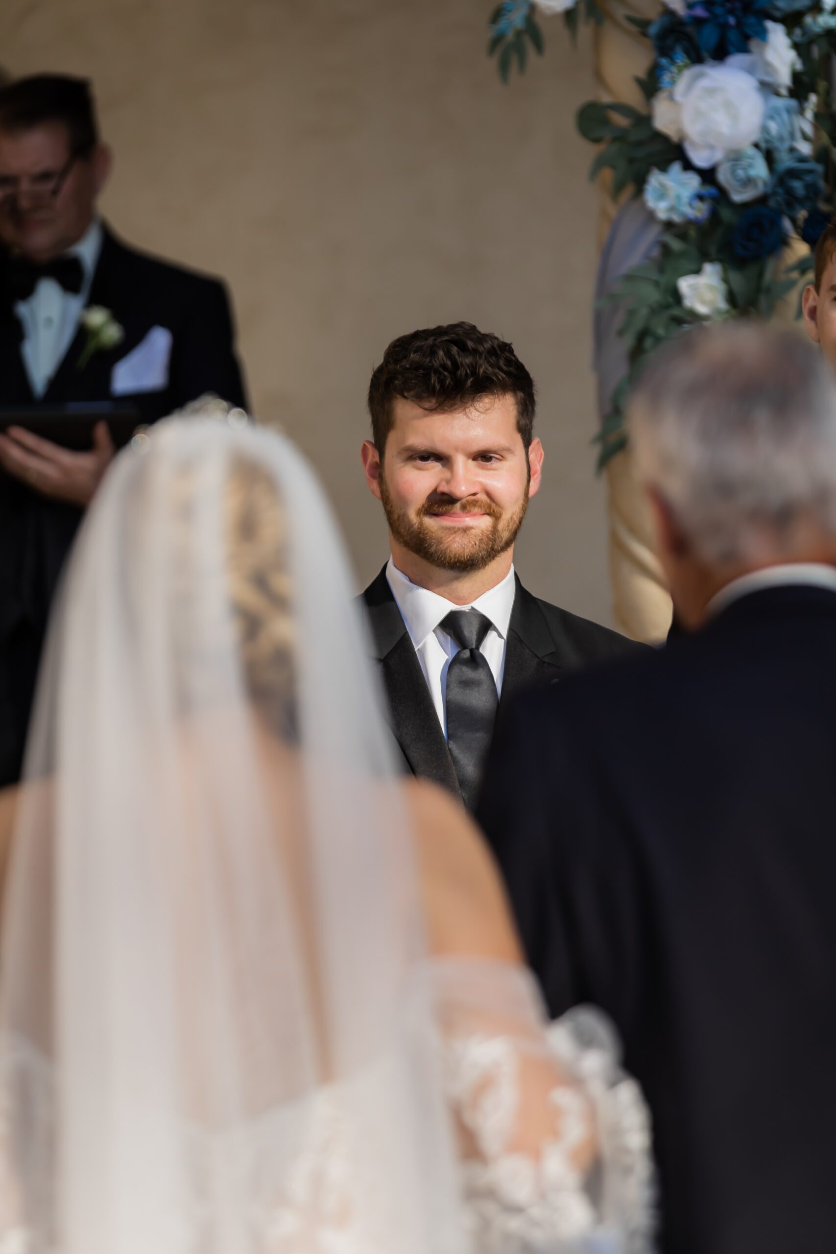 Groom watching his bride walk down the aisle