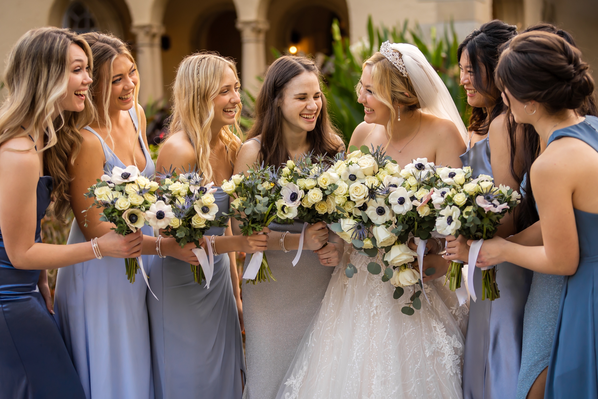 Bride Morgan laughing with her bridesmaids out front of the Powel Crosley Estate.