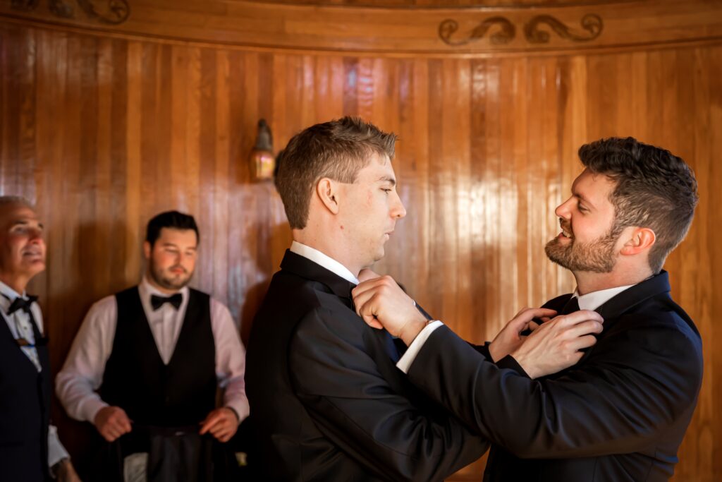 Groom and best man straighten ties before the wedding ceremony
