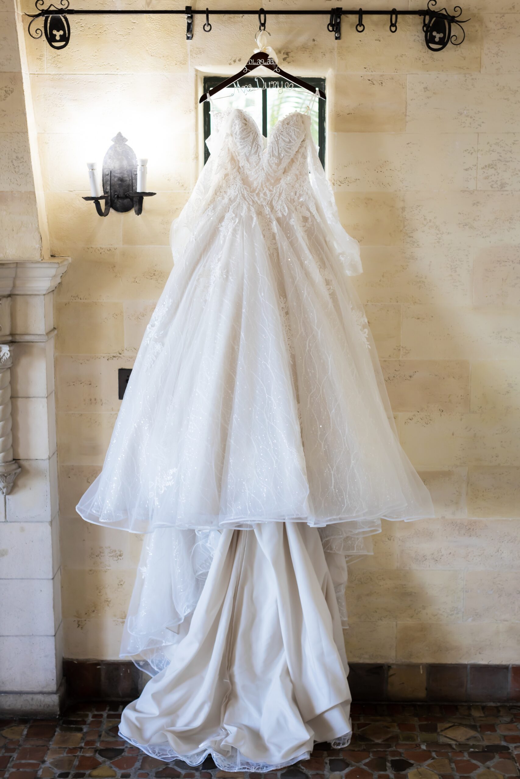 Bride's dress hanging in the window