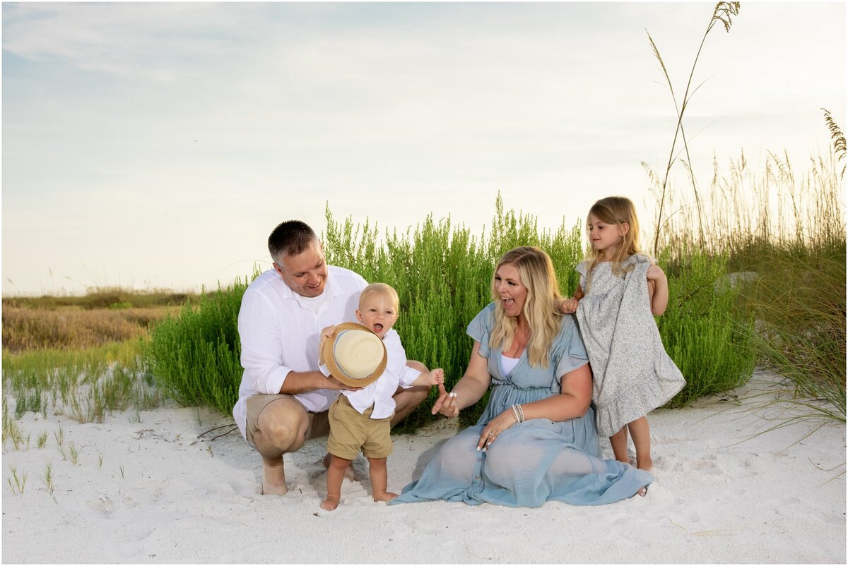 Family photoshoot on the beach in Sarasota, FL, with playful, candid moments.