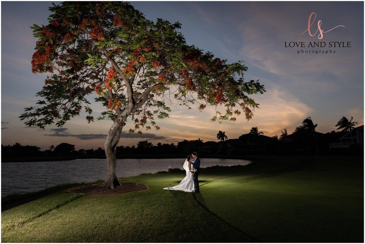 Bride and groom sharing a quiet moment under a sunset tree by the water — romantic wedding photography by Love and Style Photography in Bradenton, FL.