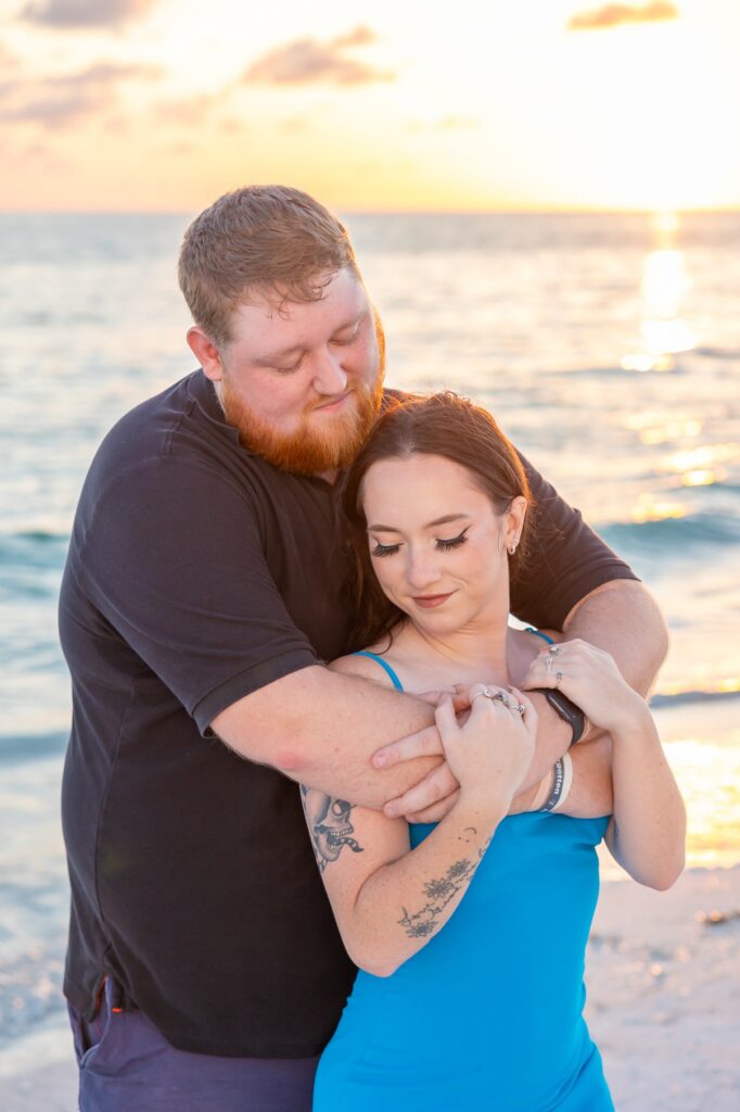 Couple posing at sunset on Lido Beach in Sarasota.
