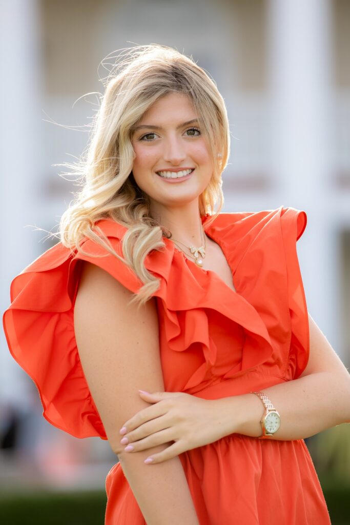 Senior girl head shot in coral dress in Sarasota, Florida.