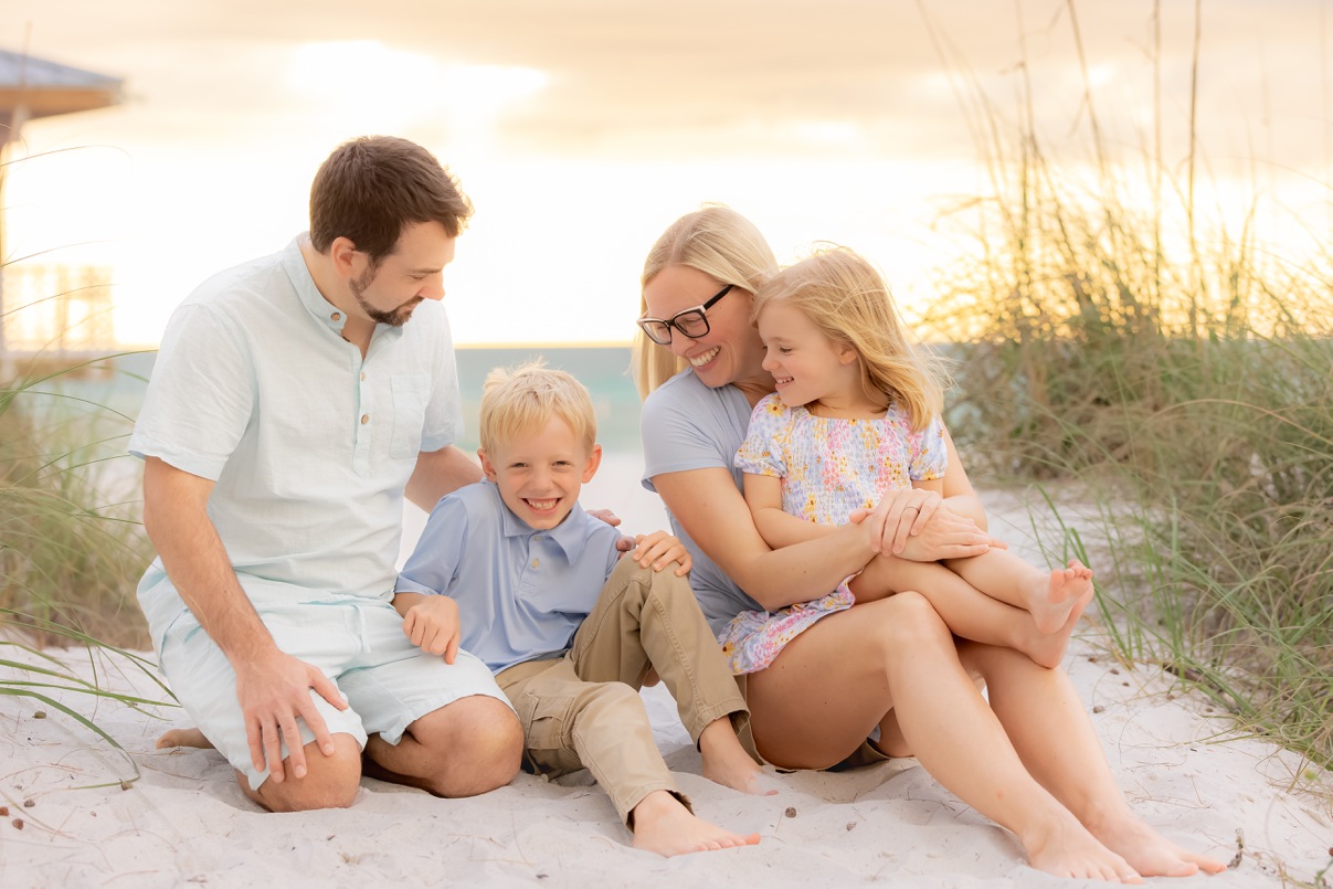 Family seated on the sand dunes on Anna Maria Island